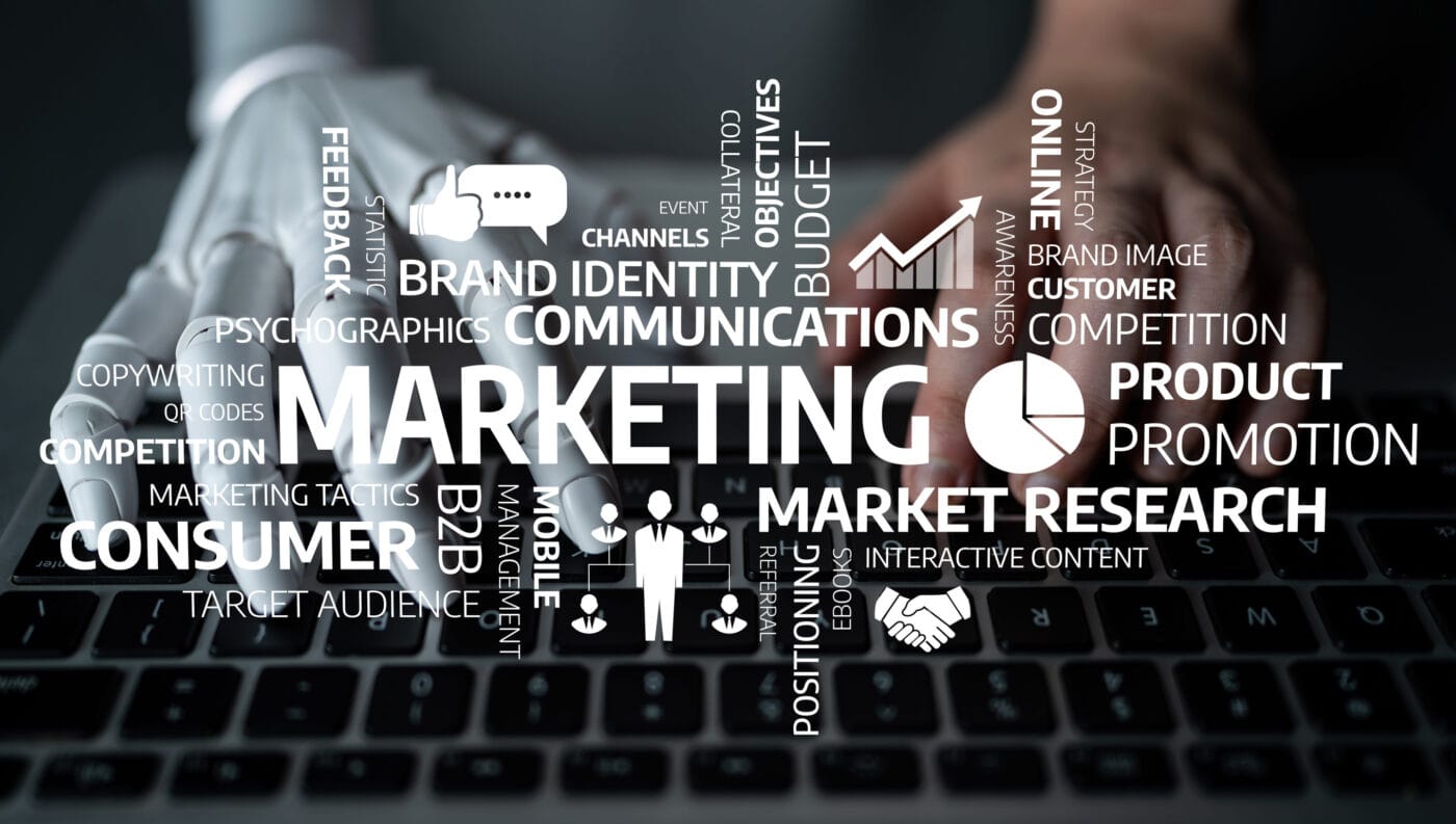 Los Bots de IA que puedes crear y te ayudarán en Marketing | El Blog de Germán Piñeiro Hands on a keyboard with a white marketing terms word cloud including Marketing, Brand Identity, PROMOTION, and Market Research overlaying the keys. El Blog de Germán Piñeiro